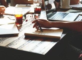 People gathered around a table trying to think of ideas.